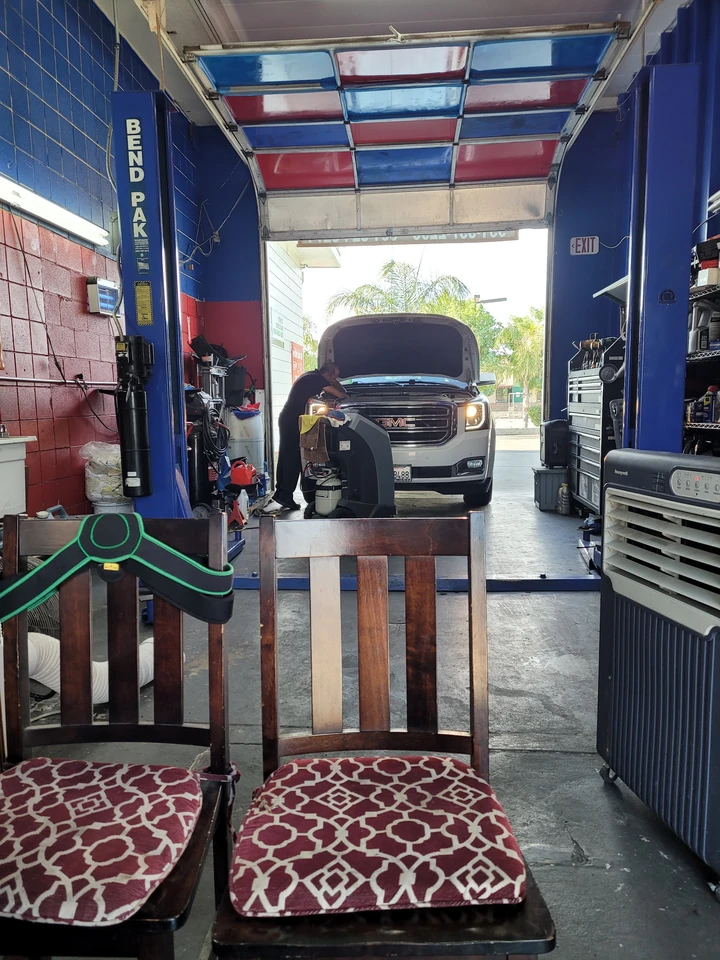 Looking out through the bay door past the lift, with a truck being worked on